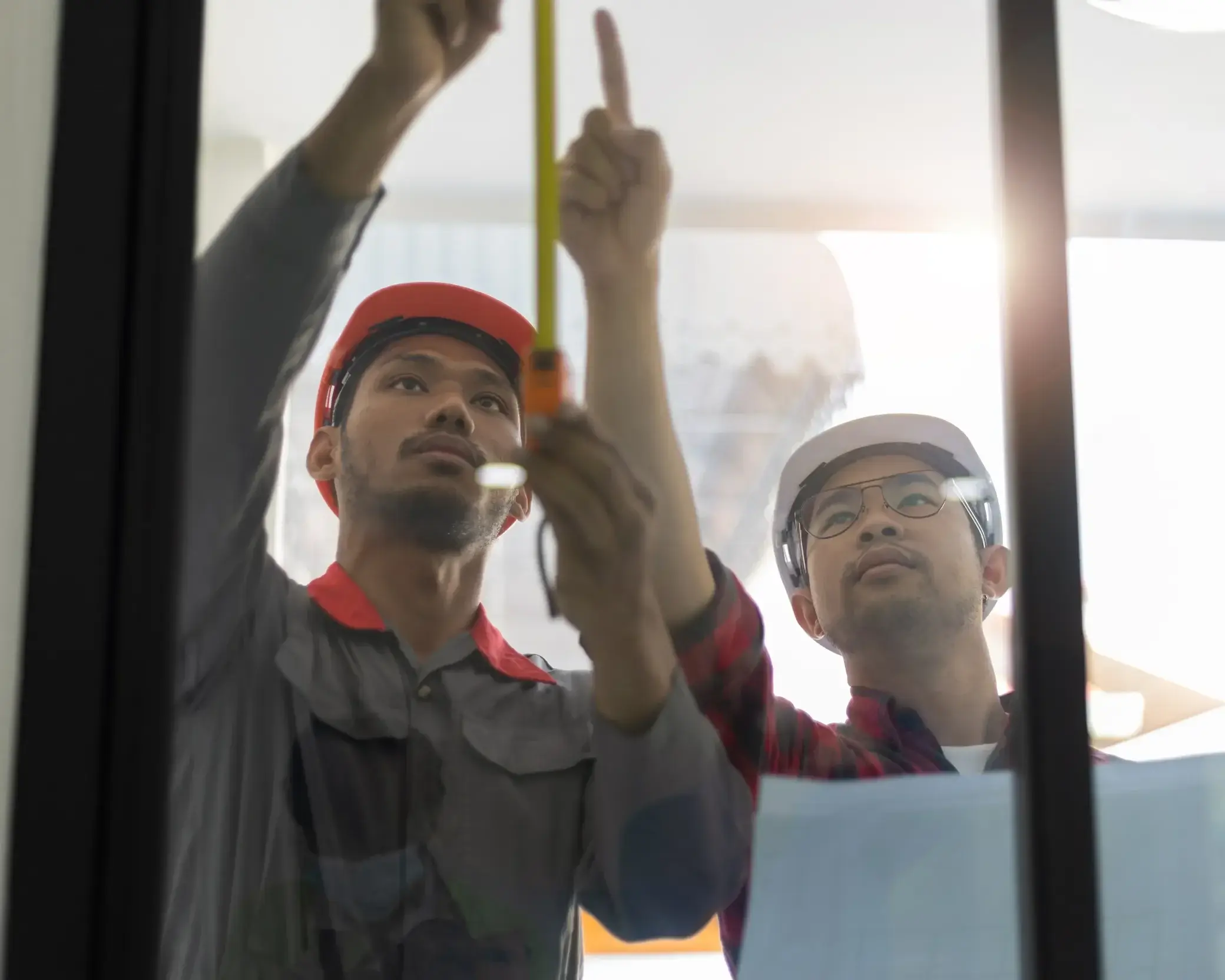 contractor-technician-measuring-glass-door-panels-home-renovation-e1740425493548-1webp - The Local Window Guy