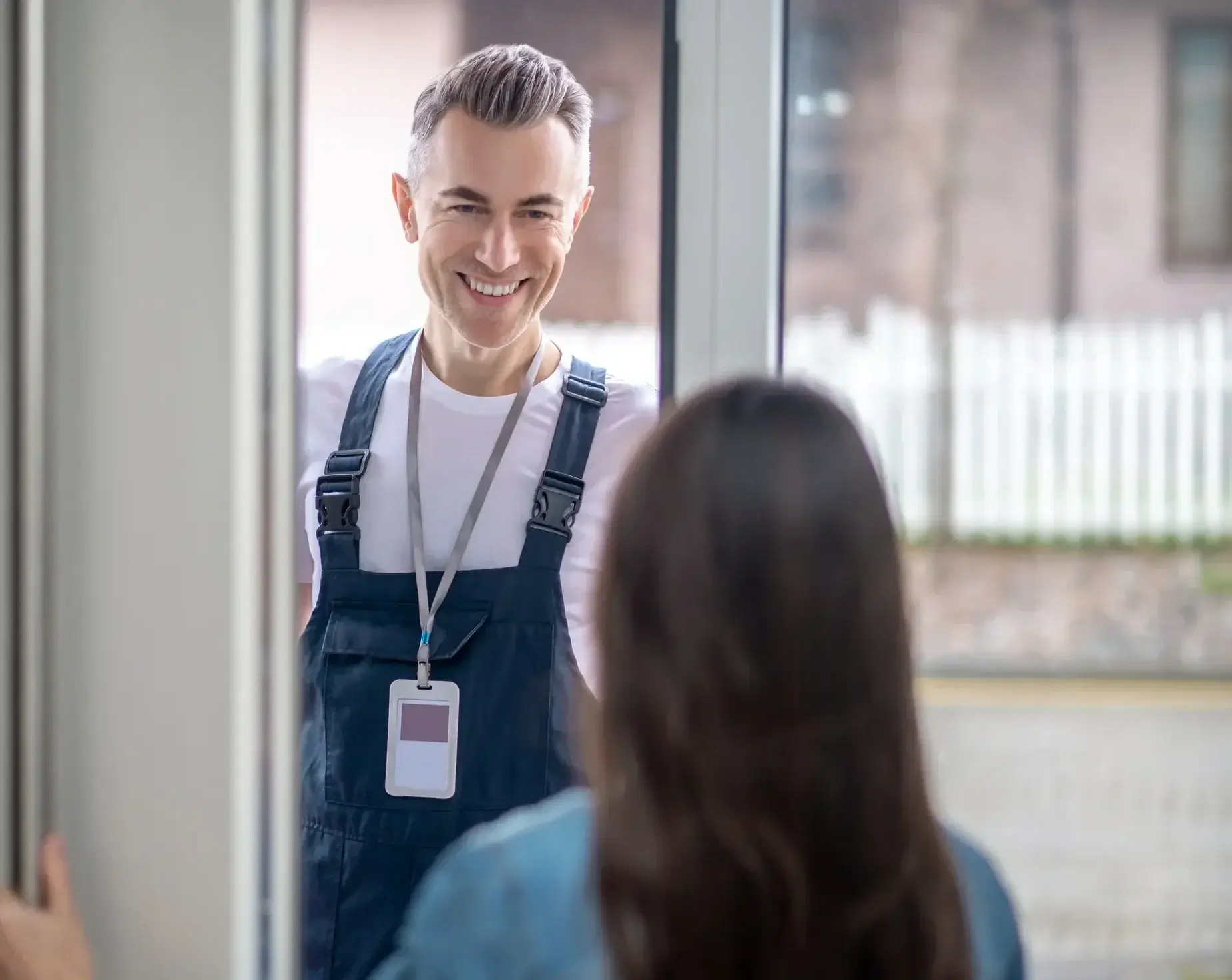 woman-with-back-camera-opening-door-man-e1740425686325-1webp - The Local Window Guy