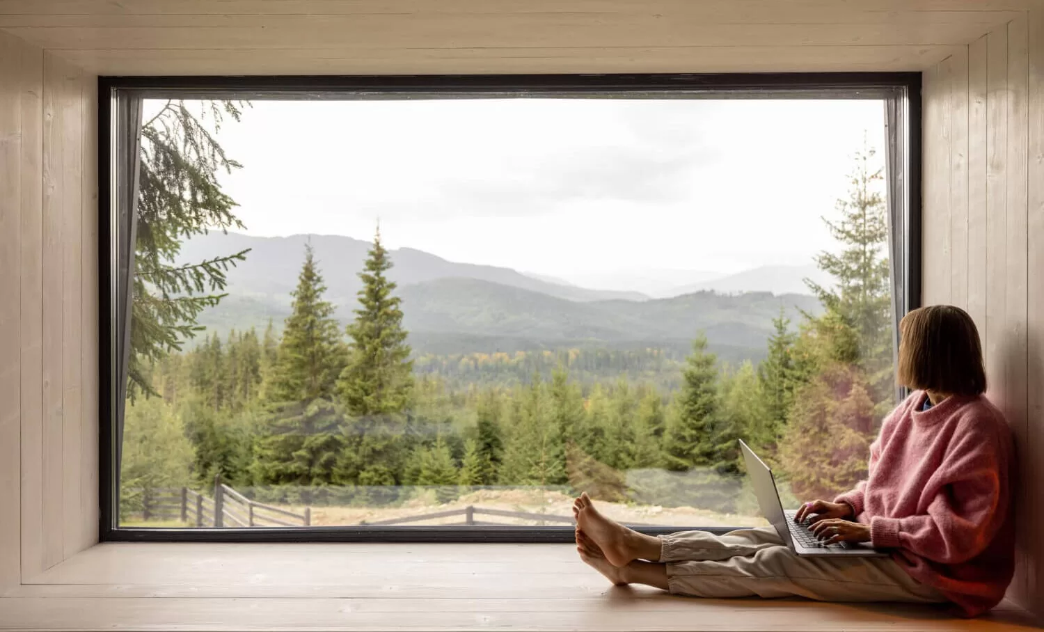 Oversized black vinyl picture window providing panoramic mountain landscape views in modern residential interior