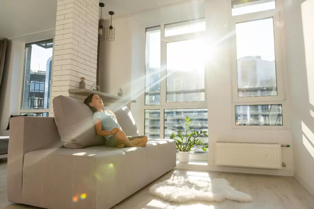 Large white vinyl replacement windows providing natural light and urban views in contemporary Canadian condo